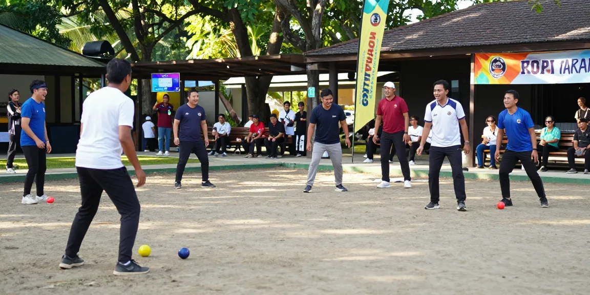 Kompetisi petanque di fopikotatarakan.org dengan pemain ceria dan suasana ramai di lapangan terbuka.