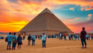 Tourists marveling at the majestic piraminds of Giza during a sunset backdrop.